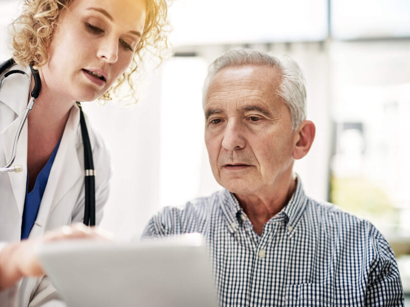 Shot of a doctor showing a senior patient some information on a digital tablet in her office