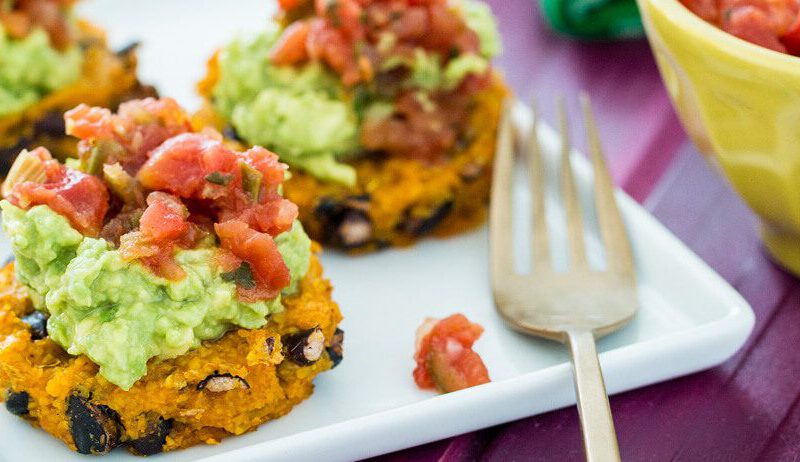 Three Polenta–Black Bean Medallions with Spicy Salsa on a white rectangle plate with a fork resting on the side
