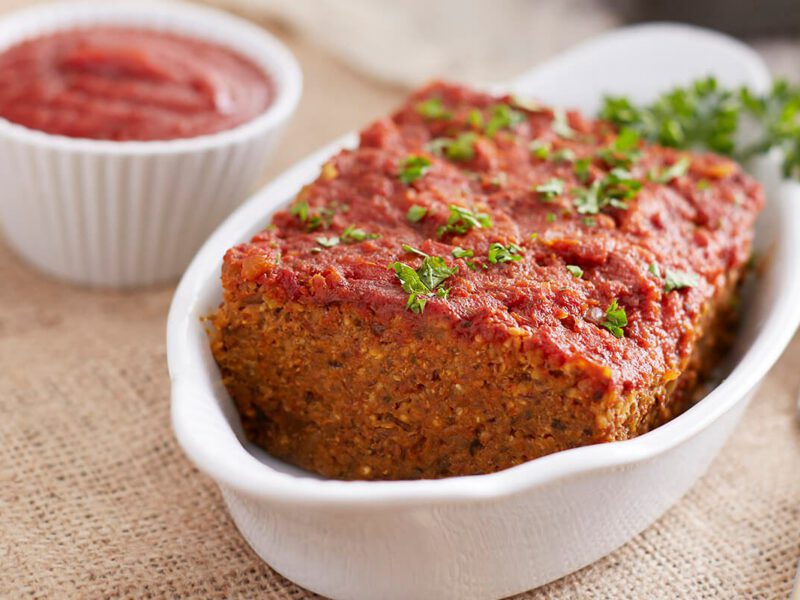 millet loaf in a white loaf-sized serving dish