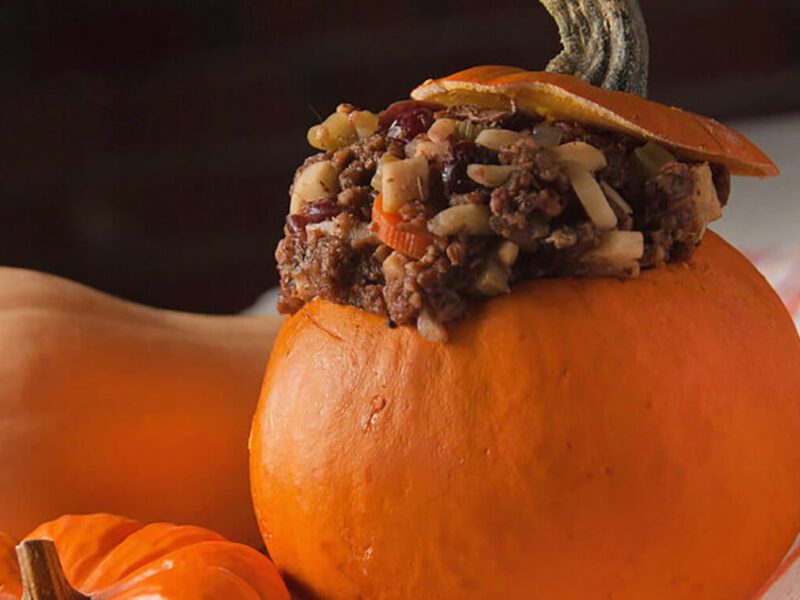 Close up of a large pumpkin stuffed with a hearty mix of lentils and veggies, aka Fire Brigade Stuffing