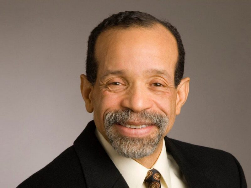 Headshot of Cardiologist Dr. Kim Williams wearing a suit and tie, smiling