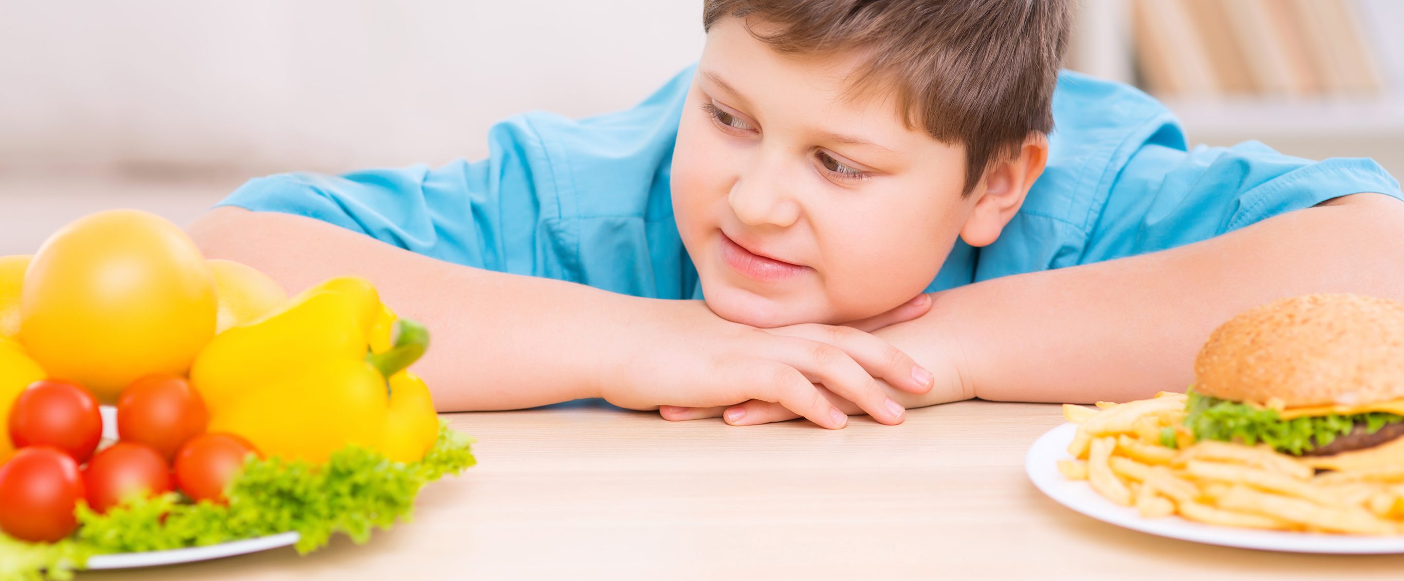 Boy deciding between health food and junk food