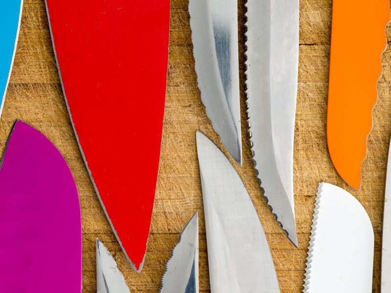 An array of kitchen knife blades, all different colors and sizes