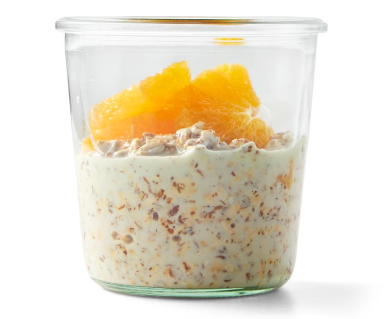 overnight oats in a glass jar topped with orange slices