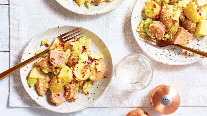 Picnic Potato Salad on white plates with metal forks