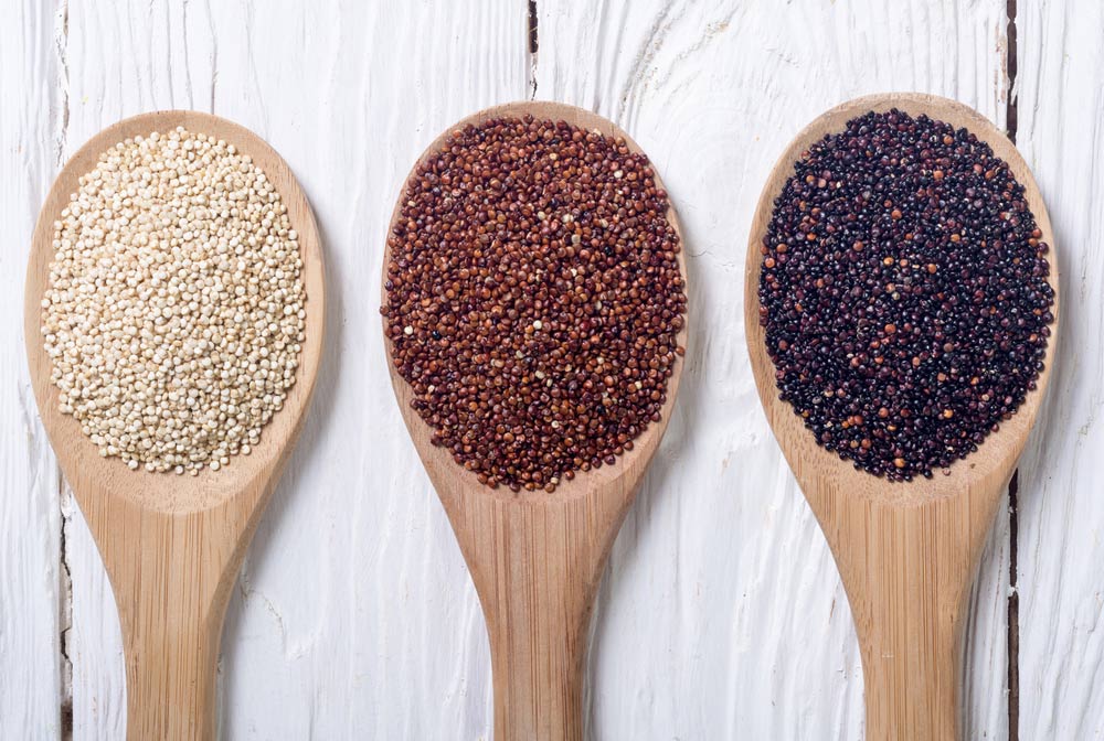 Black , white and red quinoa in spoon