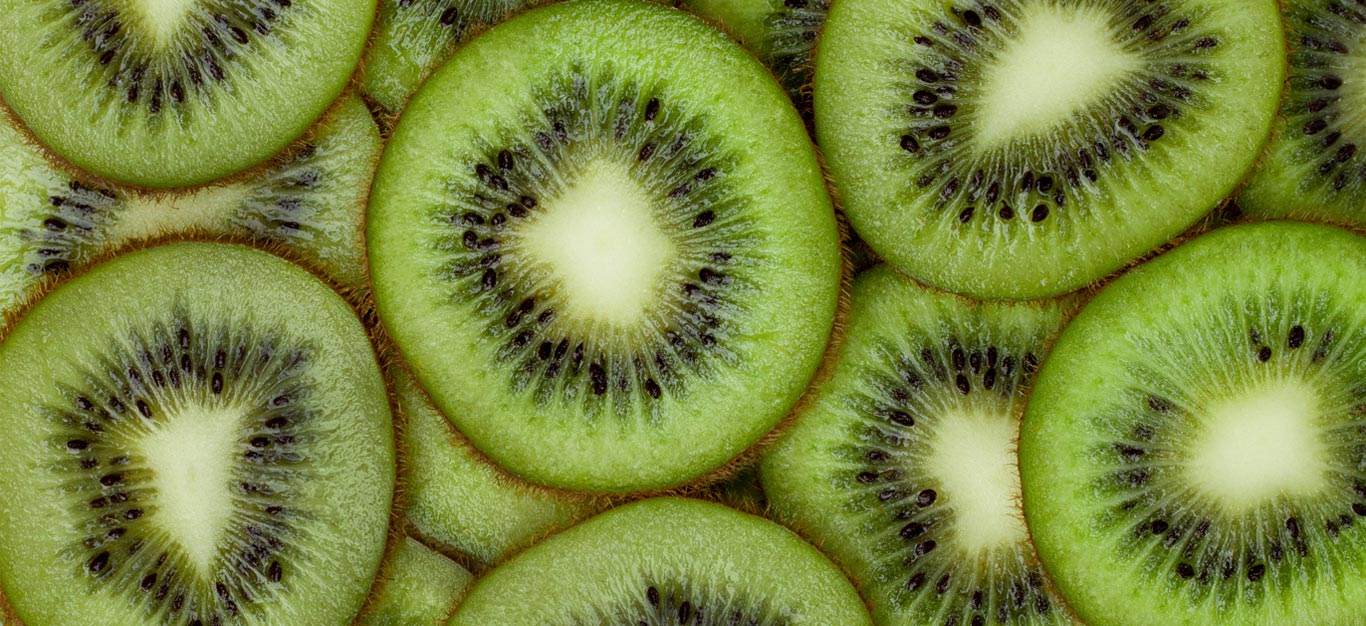 Overlapping slices of kiwi shown close up