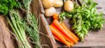 Spring vegetables on wooden background - asparagus carrots and herbs