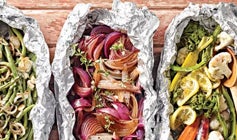 Foil packets showing various combinations of diced and seasoned veggies that are perfect healthy camping food for cooking over or in the campfire