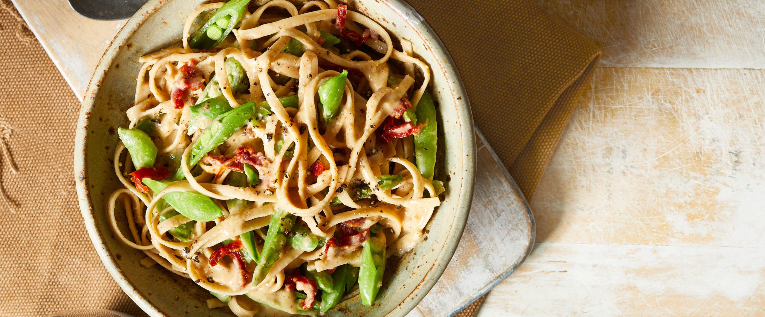 Vegan White Bean Fettuccine Alfredo with Peas and Sun-Dried Tomatoes